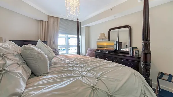 a bedroom with a bed and a large window