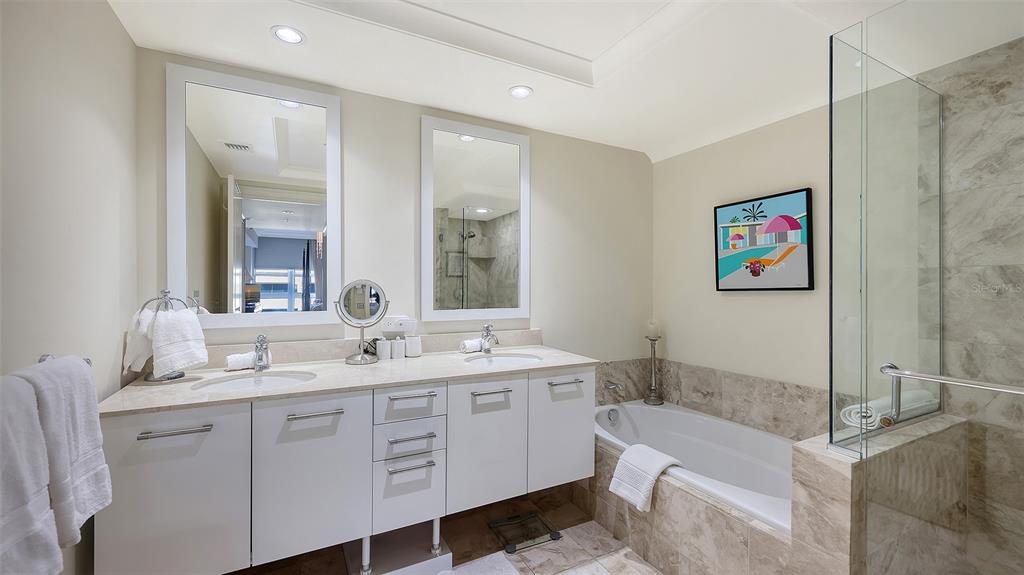 1350 Main Street, Unit 1007 Sarasota, FL 34236 - Photo 17 of 48 a bathroom with a granite countertop sink mirror and bathtub