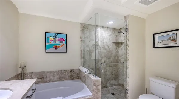 a bathroom with a shower a toilet a sink and a shower