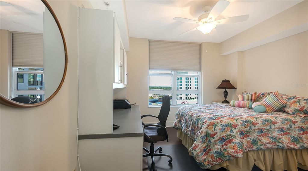 1350 Main Street, Unit 1007 Sarasota, FL 34236 - Photo 19 of 48 a bedroom with a bed and a chandelier