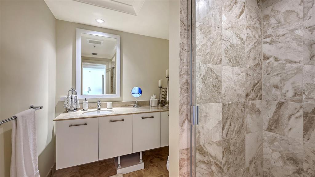 1350 Main Street, Unit 1007 Sarasota, FL 34236 - Photo 23 of 48 a bathroom with a double vanity sink and a mirror