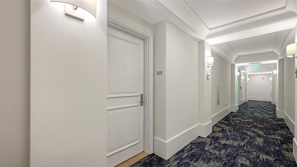 1350 Main Street, Unit 1007 Sarasota, FL 34236 - Photo 3 of 48 a view of a hallway with wooden floor and staircase