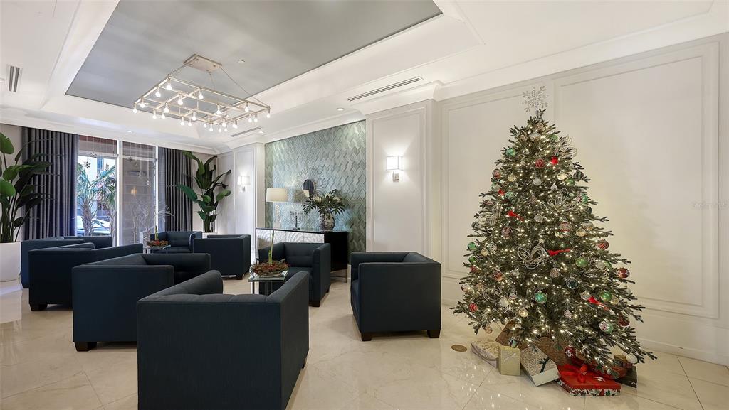 1350 Main Street, Unit 1007 Sarasota, FL 34236 - Photo 33 of 48 a living room with furniture and a chandelier