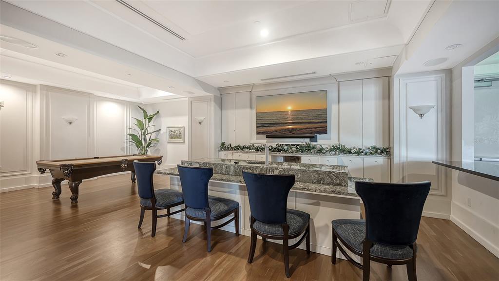1350 Main Street, Unit 1007 Sarasota, FL 34236 - Photo 35 of 48 a view of a dining room with furniture and wooden floor