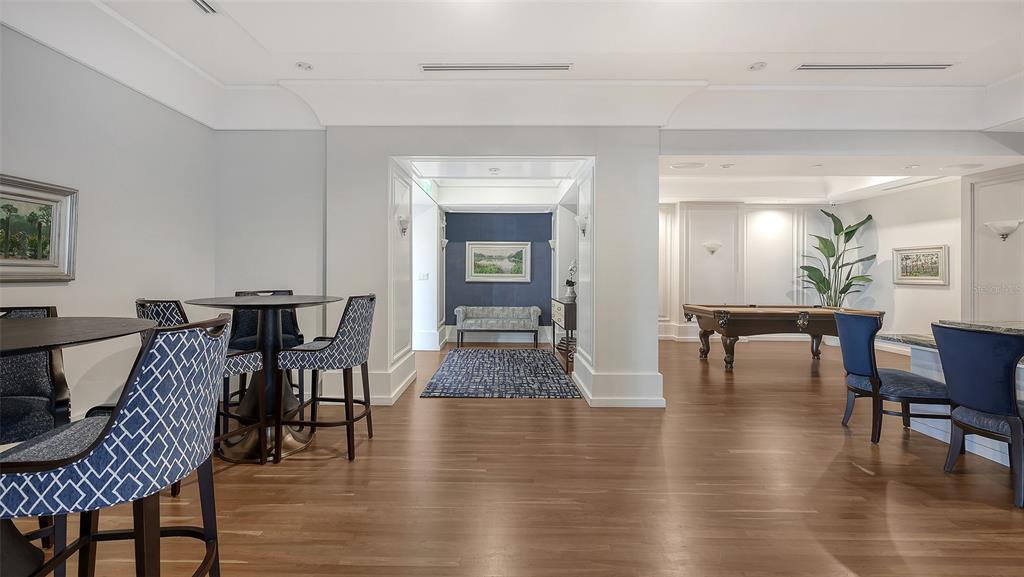 1350 Main Street, Unit 1007 Sarasota, FL 34236 - Photo 36 of 48 a view of a dining room with furniture and wooden floor