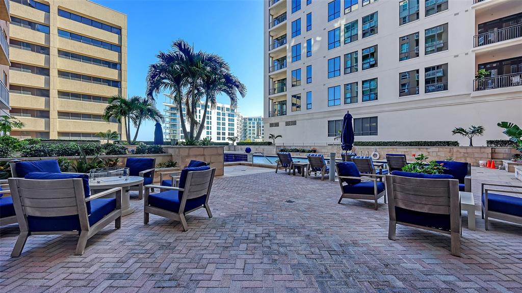 1350 Main Street, Unit 1007 Sarasota, FL 34236 - Photo 45 of 48 a backyard of a house with barbeque oven table and chairs