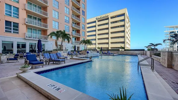 a view of a swimming pool with outdoor seating