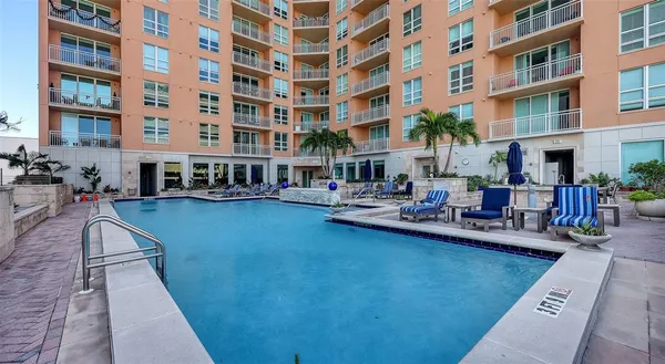 a view of a swimming pool with outdoor seating