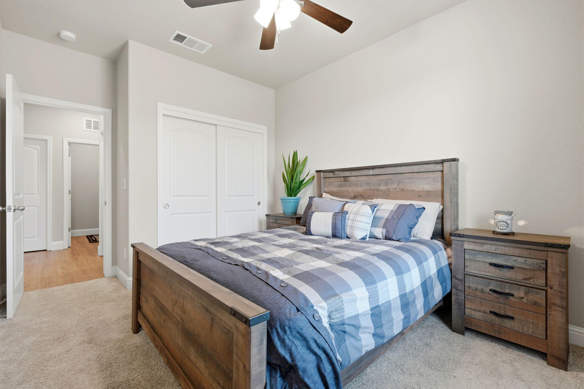 756 Strada Street Lemoore, CA 93245 - Photo 24 of 53 a bedroom with a bed and a chandelier