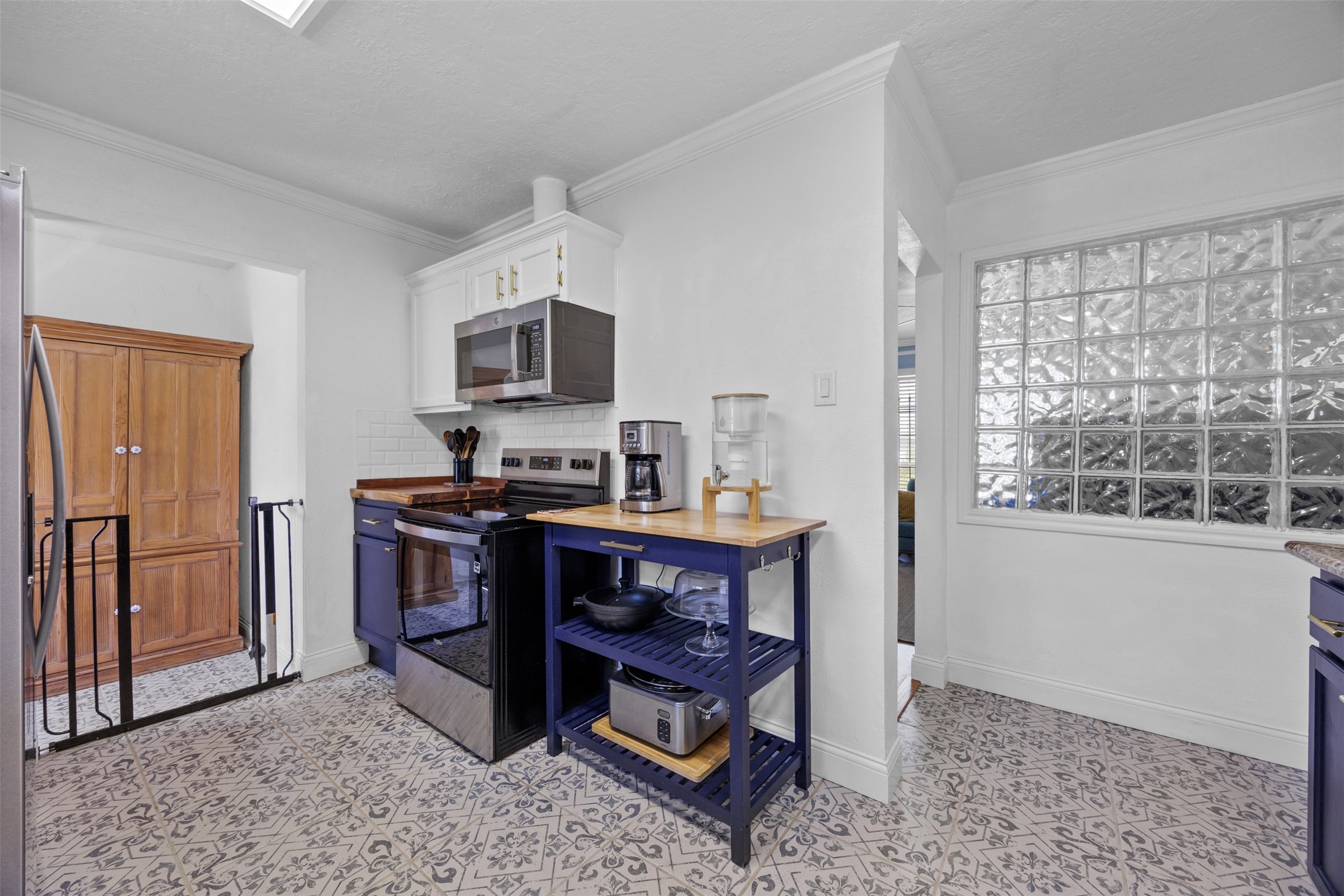 5874 Beldart Street Houston, TX 77033 - Photo 12 of 37 Kitchen with additional storage space to the left and convenient access to the backyard; as shown, this area can also be used as a pet-friendly space.