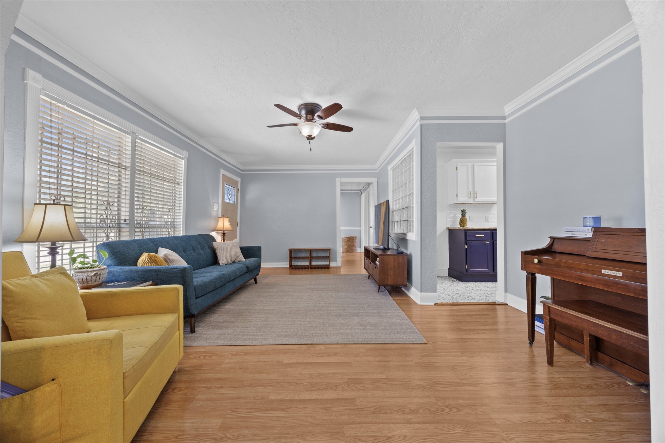5874 Beldart Street Houston, TX 77033 - Photo 13 of 37 Returning through the living area, the hallway leads to the bedrooms and bathroom.