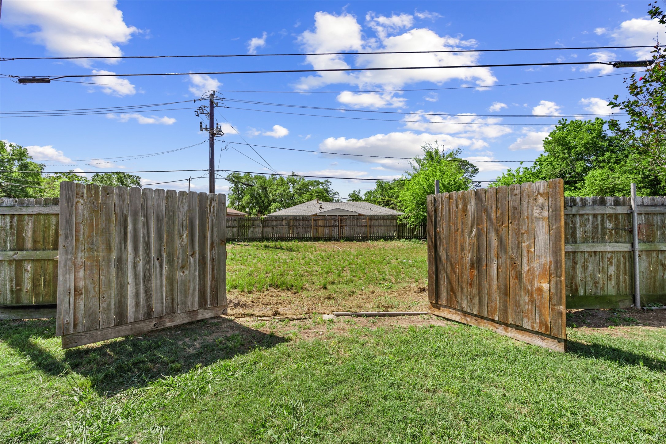 5874 Beldart Street Houston, TX 77033 - Photo 23 of 37 Backyard features a wide double-gate entry, providing added flexibility for access and storage needs.