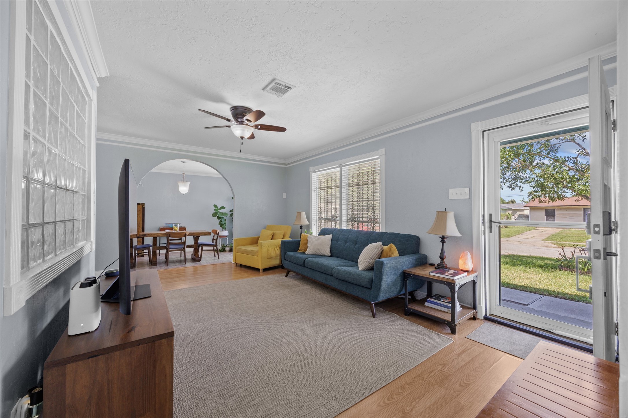 5874 Beldart Street Houston, TX 77033 - Photo 5 of 37 Light-filled living area with views to the front yard and a seamless flow into the dining space beyond.