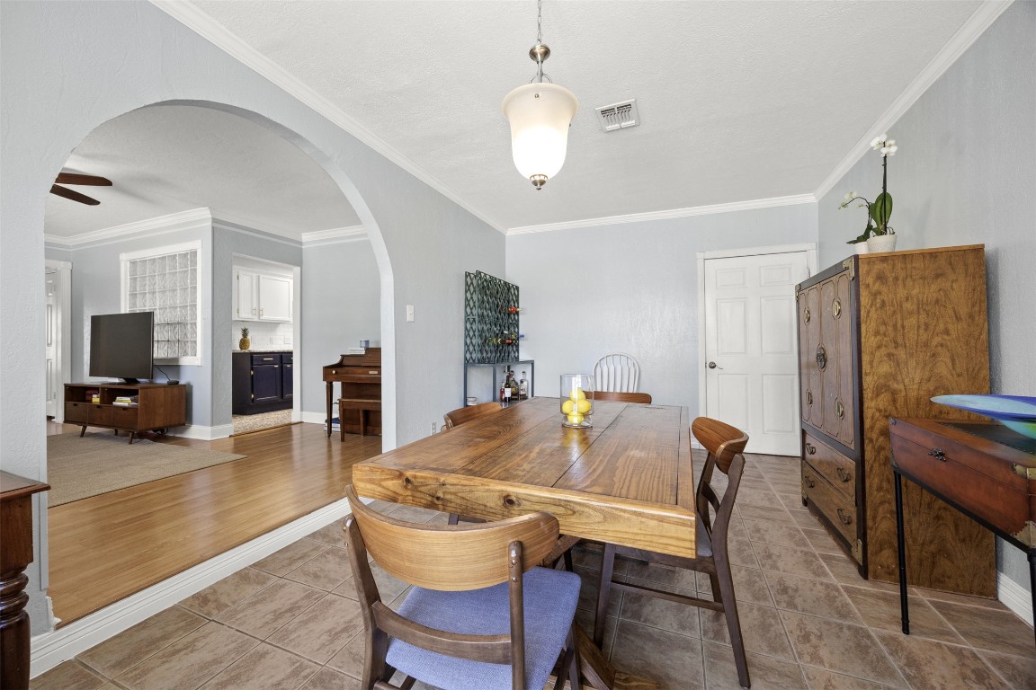 5874 Beldart Street Houston, TX 77033 - Photo 8 of 37 Well-positioned dining space with a natural flow into the kitchen on the left and easy access to laundry behind the door at the back right.