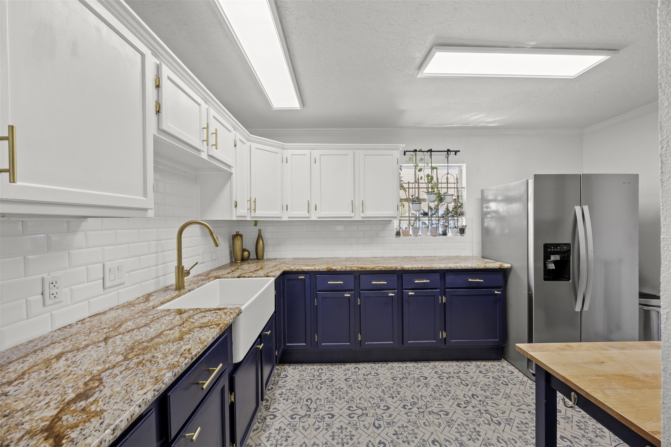 5874 Beldart Street Houston, TX 77033 - Photo 9 of 37 Updated kitchen featuring granite countertops, a farmhouse sink, and stylish tile backsplash.