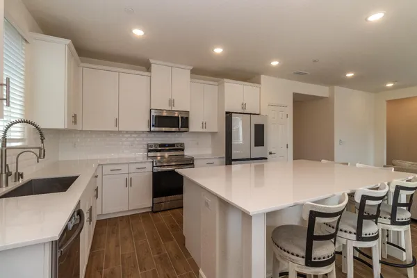 a spacious bathroom with a tub sink and mirror
