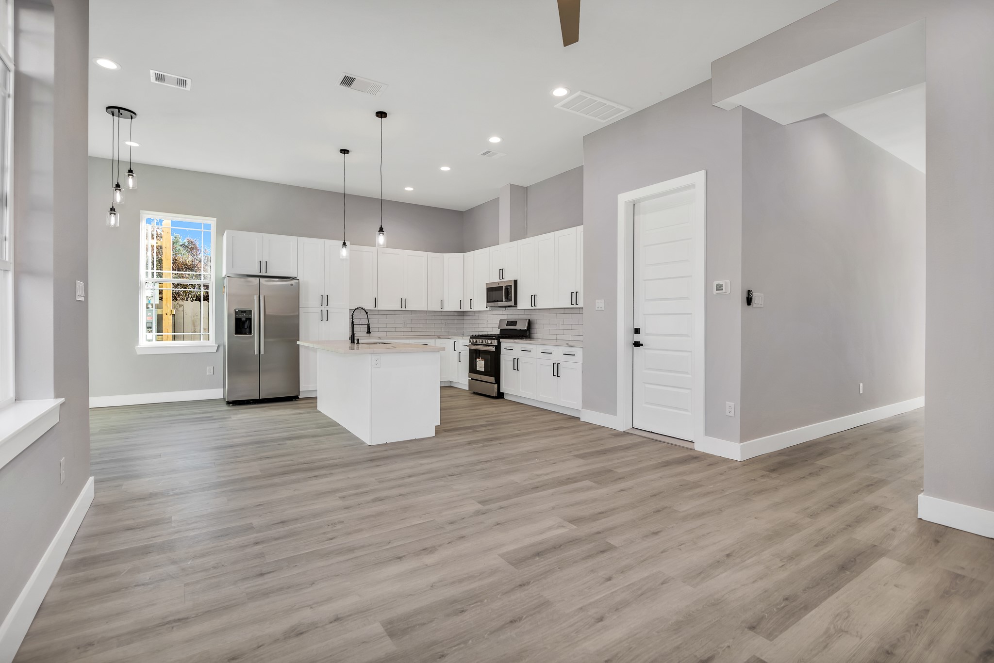 4924 Winnetka Street, Unit A Houston, TX 77021 - Photo 11 of 26 a view of kitchen view wooden floor cabinets and stainless steel appliances