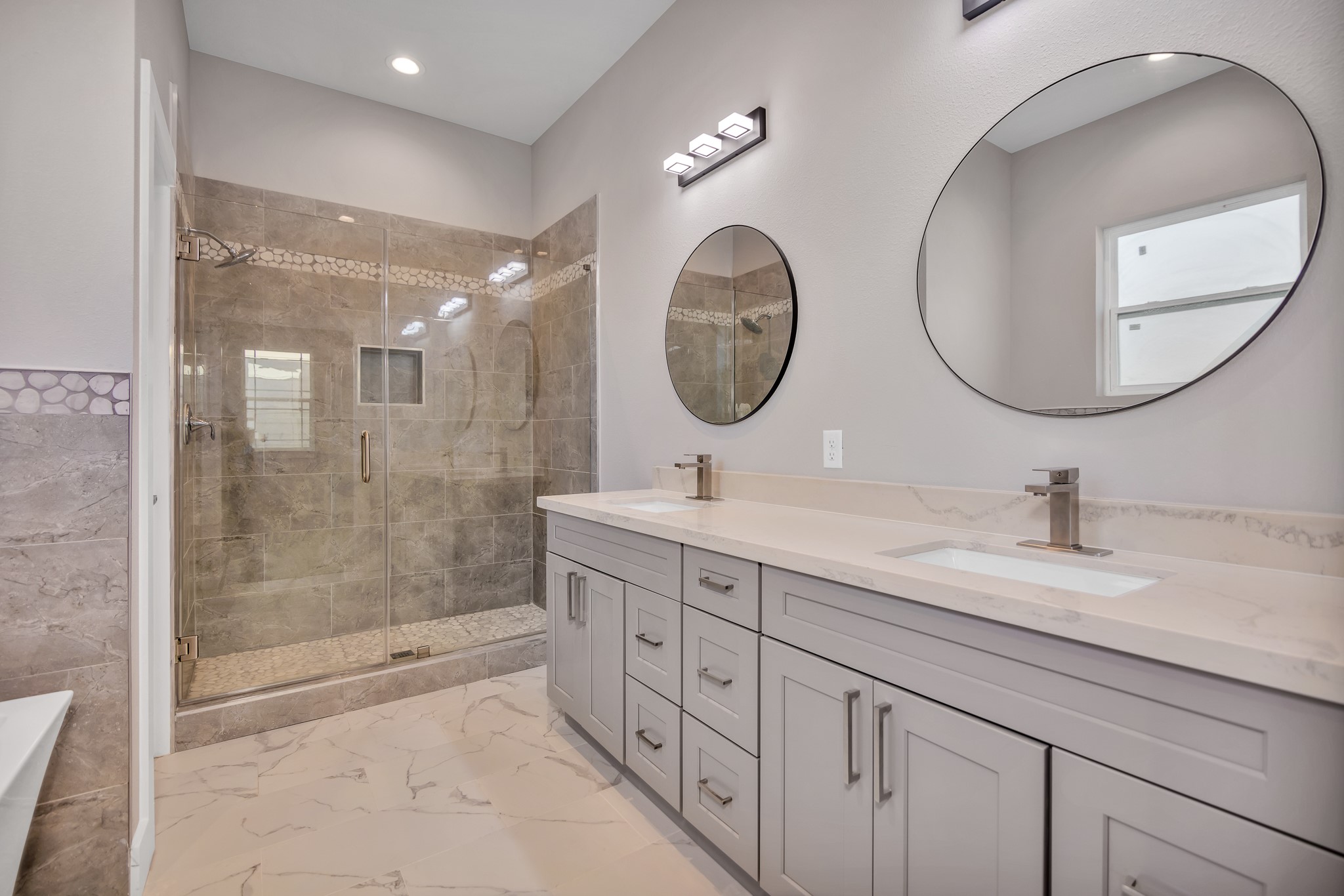 4924 Winnetka Street, Unit A Houston, TX 77021 - Photo 18 of 26 a bathroom with a double vanity sink mirror and shower