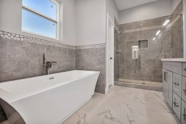 a bathroom with a bathtub and shower