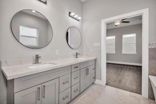 a bathroom with a double vanity sink and a mirror