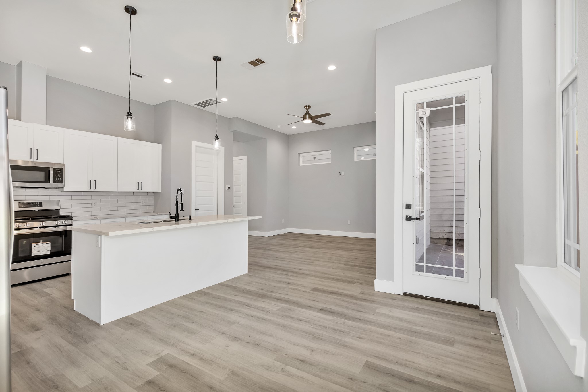 4924 Winnetka Street, Unit A Houston, TX 77021 - Photo 2 of 26 a large kitchen with white cabinets and stainless steel appliances