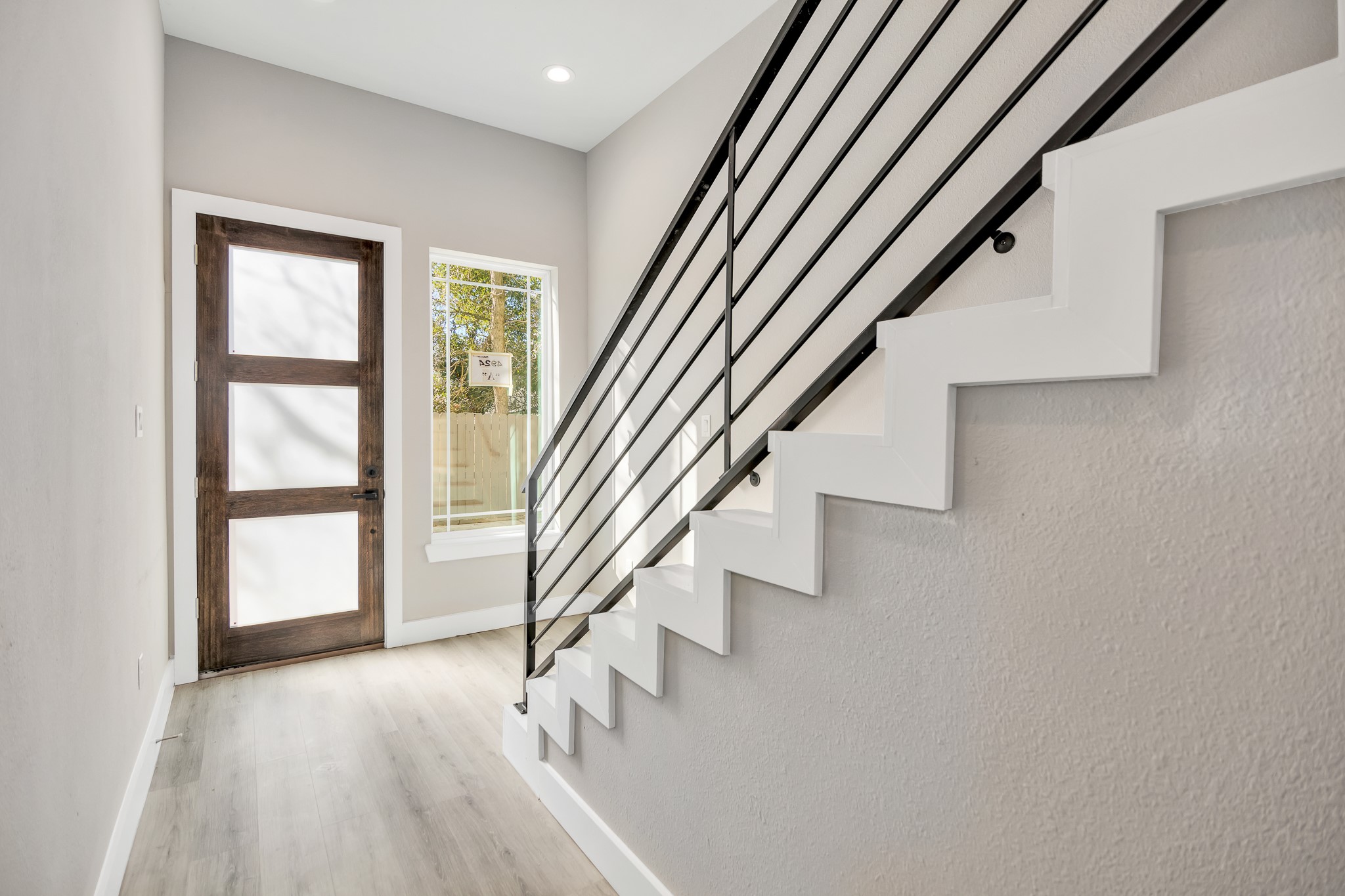 4924 Winnetka Street, Unit A Houston, TX 77021 - Photo 3 of 26 an entryway in a hall with a window and wooden floor