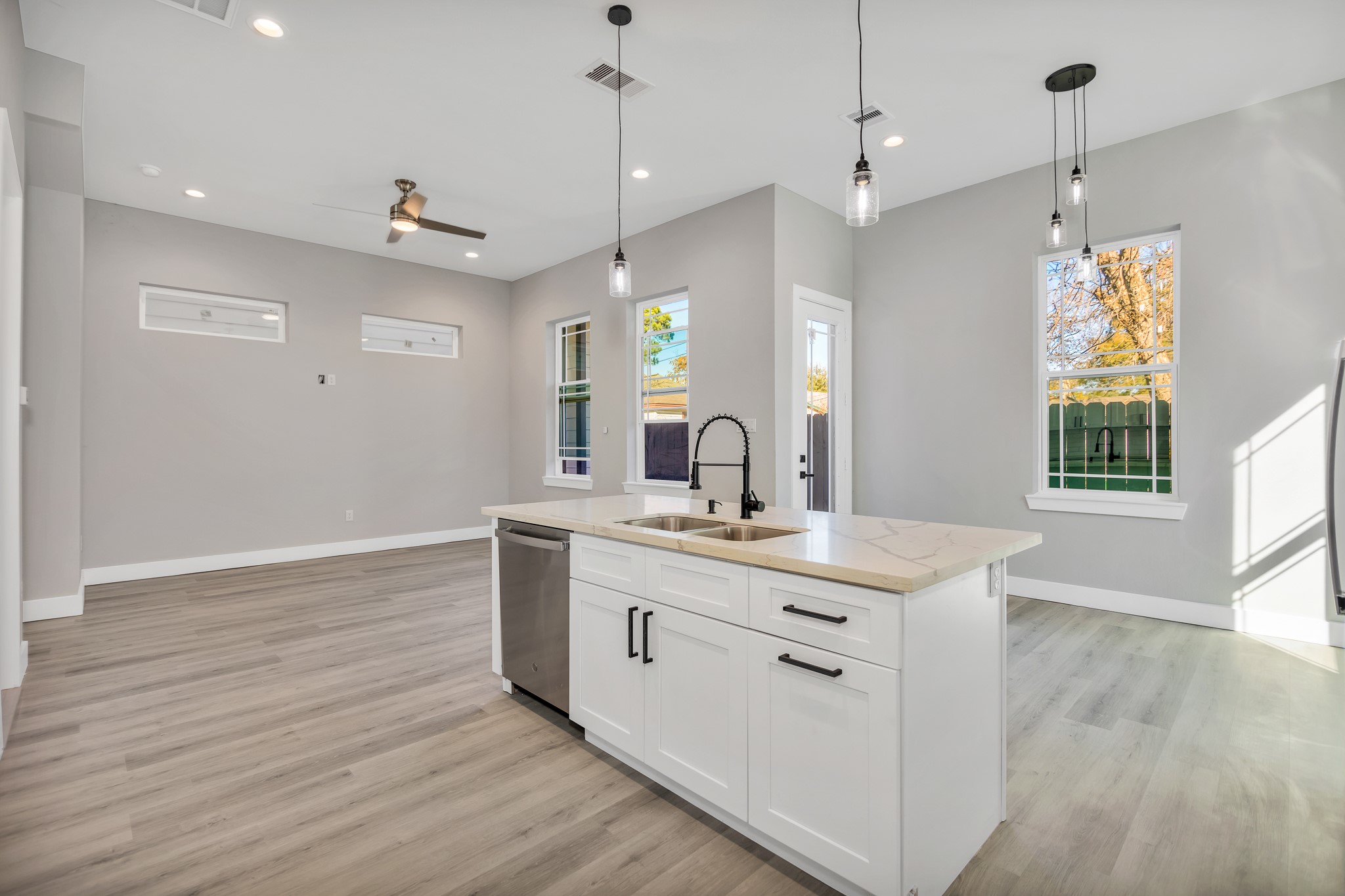 4924 Winnetka Street, Unit A Houston, TX 77021 - Photo 7 of 26 a view of a kitchen counter space a sink wooden floor and windows