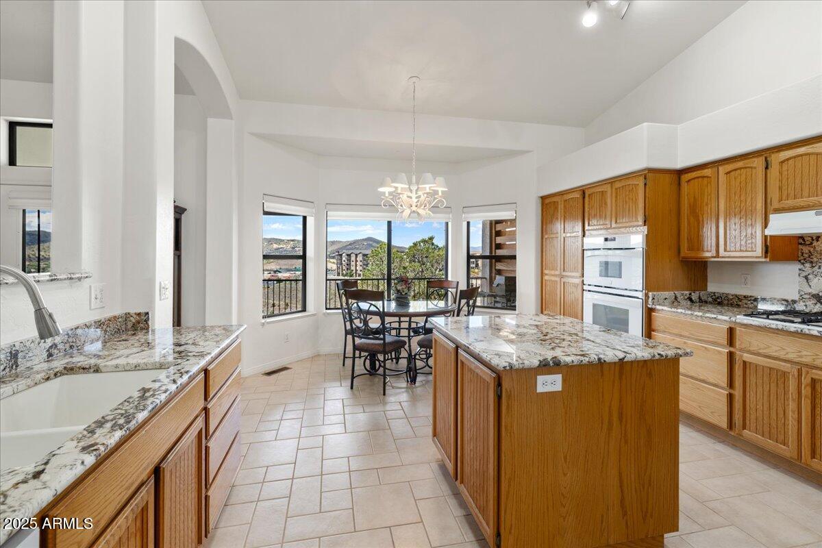 528 Miracle Rider Road Prescott, AZ 86301 - Photo 11 of 47 a kitchen with stainless steel appliances granite countertop table chairs sink and cabinets