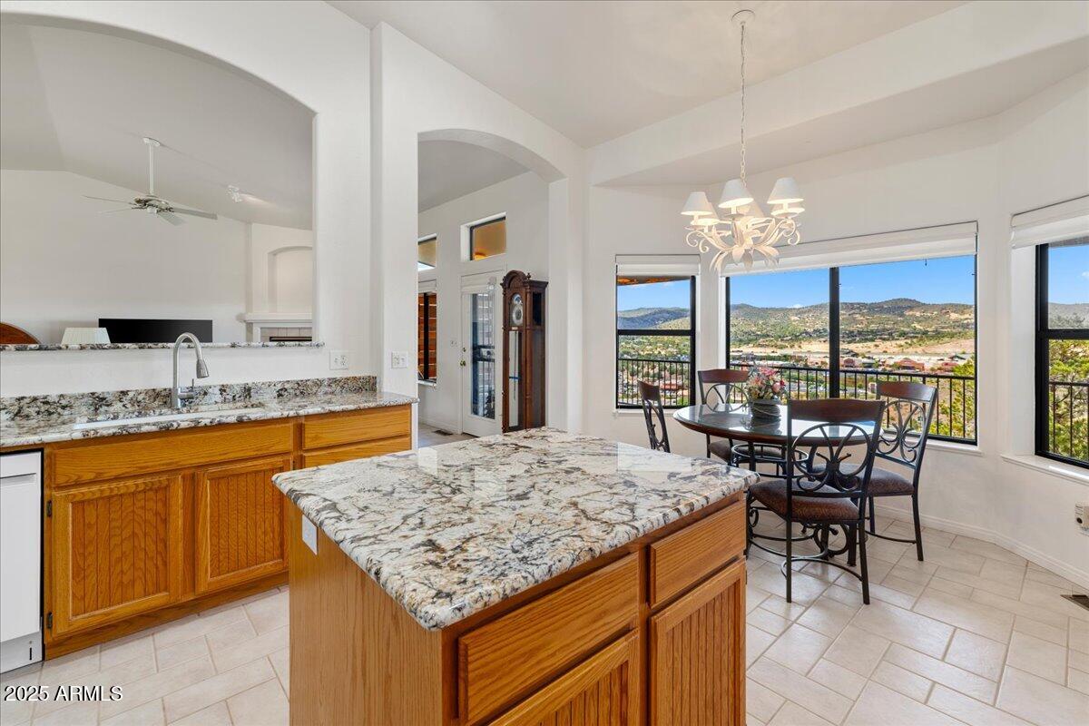 528 Miracle Rider Road Prescott, AZ 86301 - Photo 12 of 47 a view of a kitchen area kitchen island dining table and chandelier