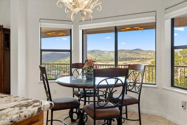 a view of a dining room with furniture large windows and wooden floor