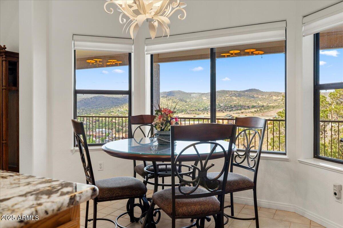 528 Miracle Rider Road Prescott, AZ 86301 - Photo 15 of 47 a view of a dining room with furniture large windows and wooden floor