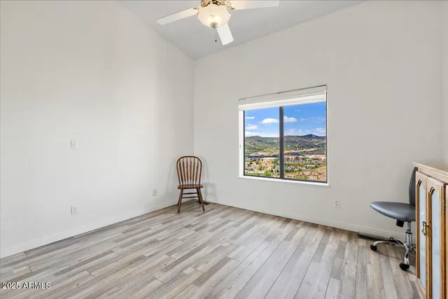 a view of a livingroom with a chair and a window