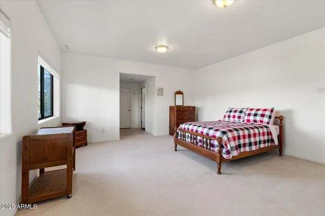 a bedroom with a bed and a chair in it