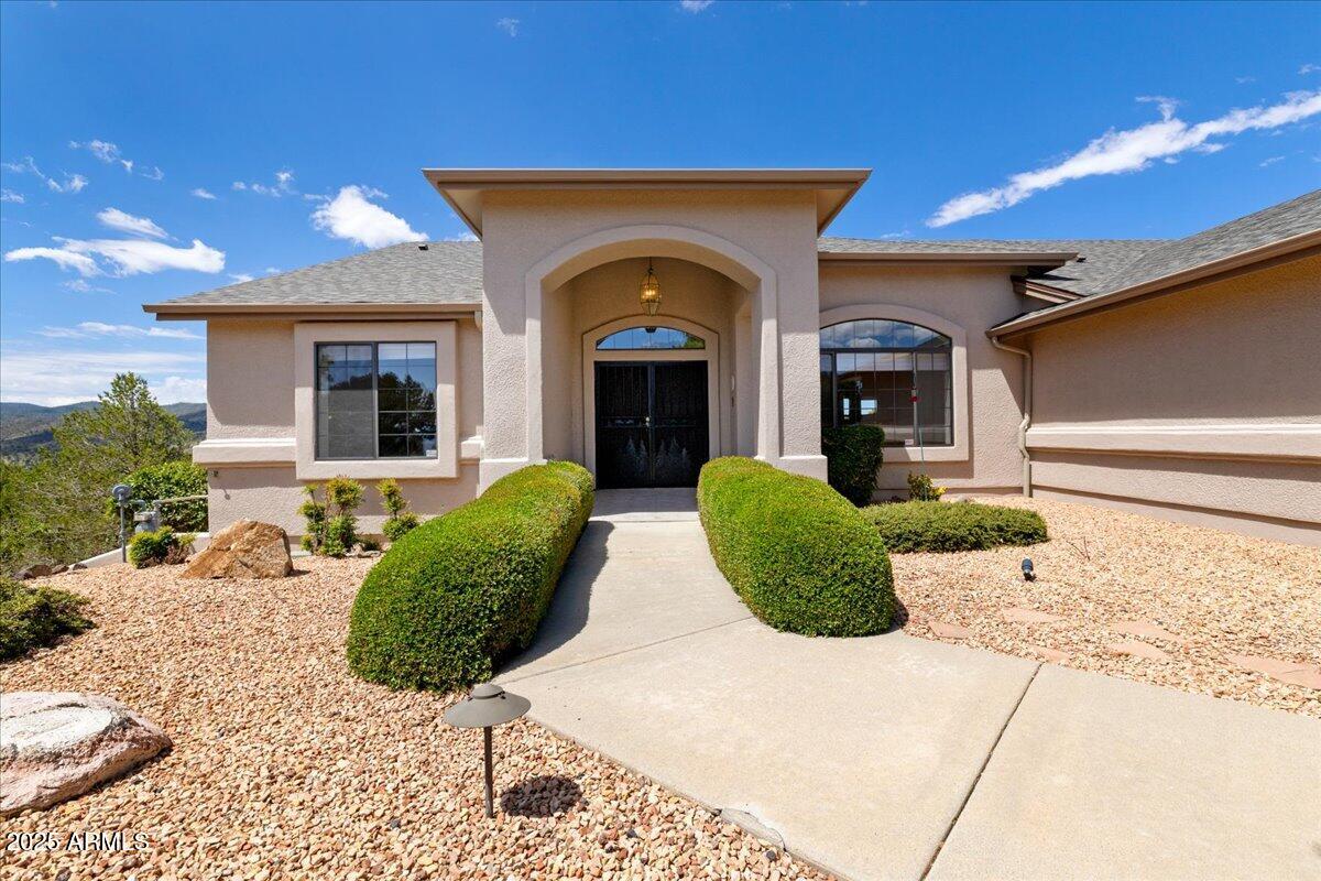 528 Miracle Rider Road Prescott, AZ 86301 - Photo 3 of 47 a view of a grey house with a yard