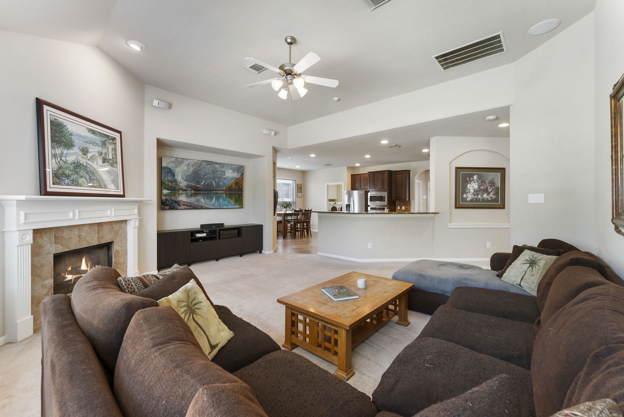 19223 Senterra Lakes Boulevard Spring, TX 77379 - Photo 22 of 48 a living room with furniture kitchen view and a fireplace