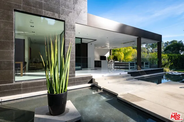 a lobby with a table and potted plants