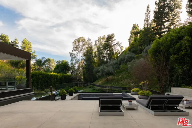 a view of backyard with seating area and green space
