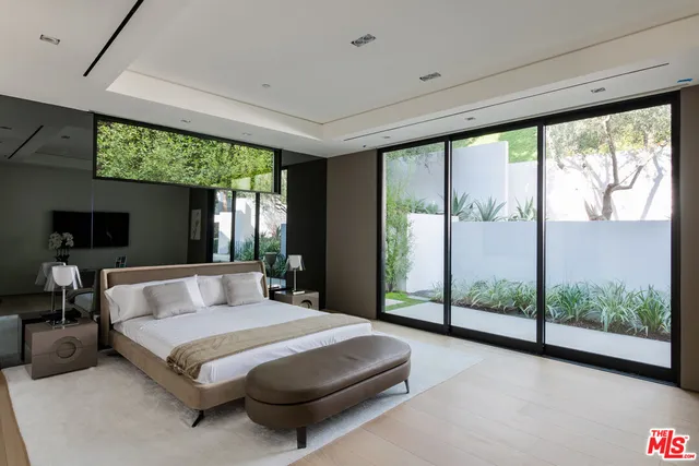 a bedroom with a large bed and a large window