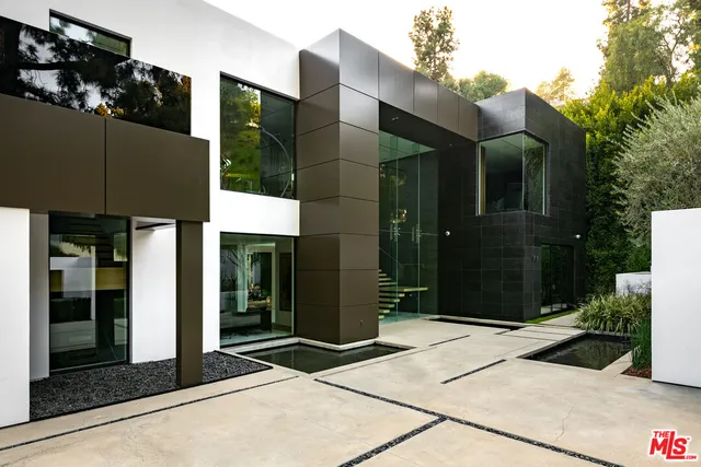a bathroom with a glass door shower and sink