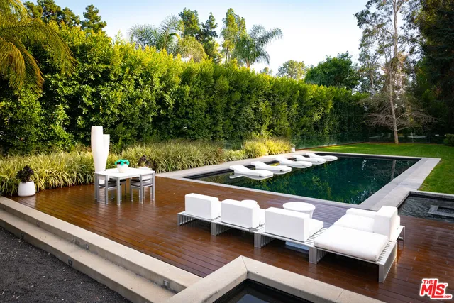 a view of a swimming pool with lounge chairs