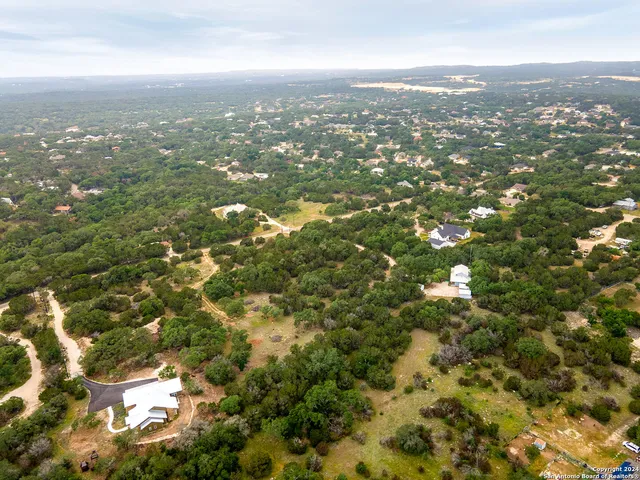an aerial view of residential houses with city view