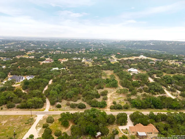 an aerial view of residential houses with city view