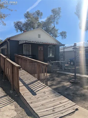 a view of a house with wooden fence
