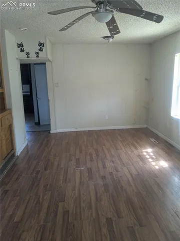 a view of a room with wooden floor
