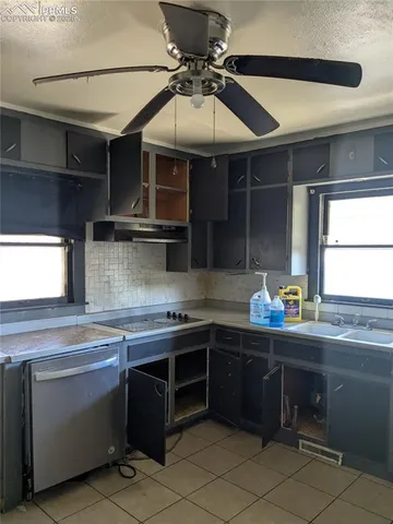 a kitchen with a sink and cabinets
