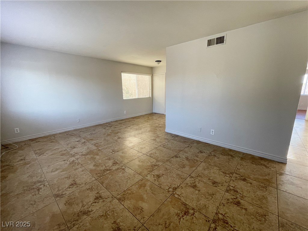 5447 Retablo Avenue, Unit 4 Las Vegas, NV 89103 - Photo 3 of 16 Spare room featuring baseboards