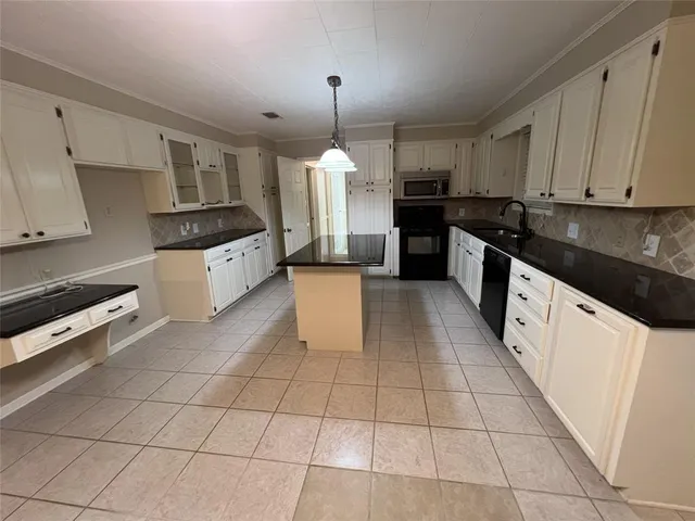 a view of an empty room with wooden floor and a fireplace