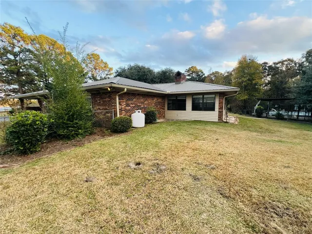 a front view of a house with yard and green space