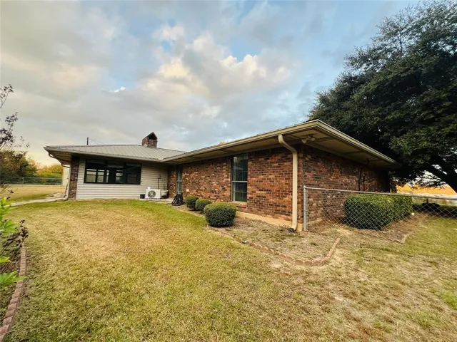 a front view of a house with yard and garage