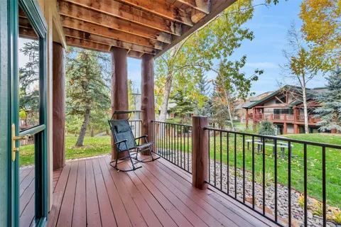 a view of roof deck with wooden floor and seating space